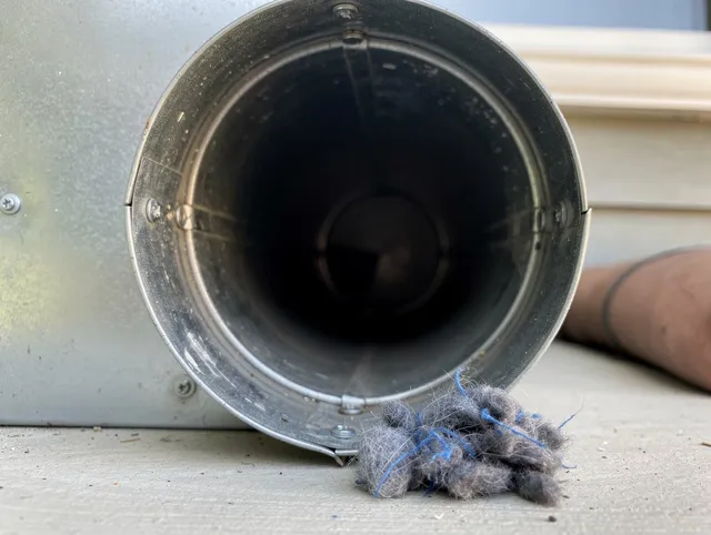 Middleburg Heights Dryer Vent Cleaning technician using specialized equipment to clear severe dryer vent blockage in Middleburg Heights